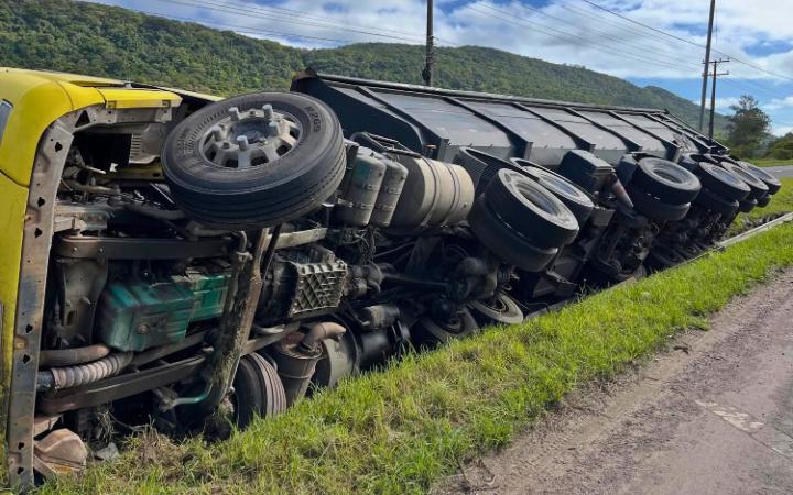 Caminhão carregado de cascalho tomba na BR-101, em Osório